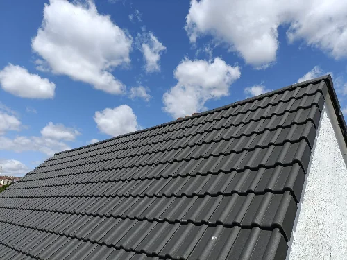 A newly installed dark grey tiled roof on a Bristol house